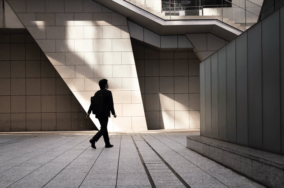 A professional walking through a financial district